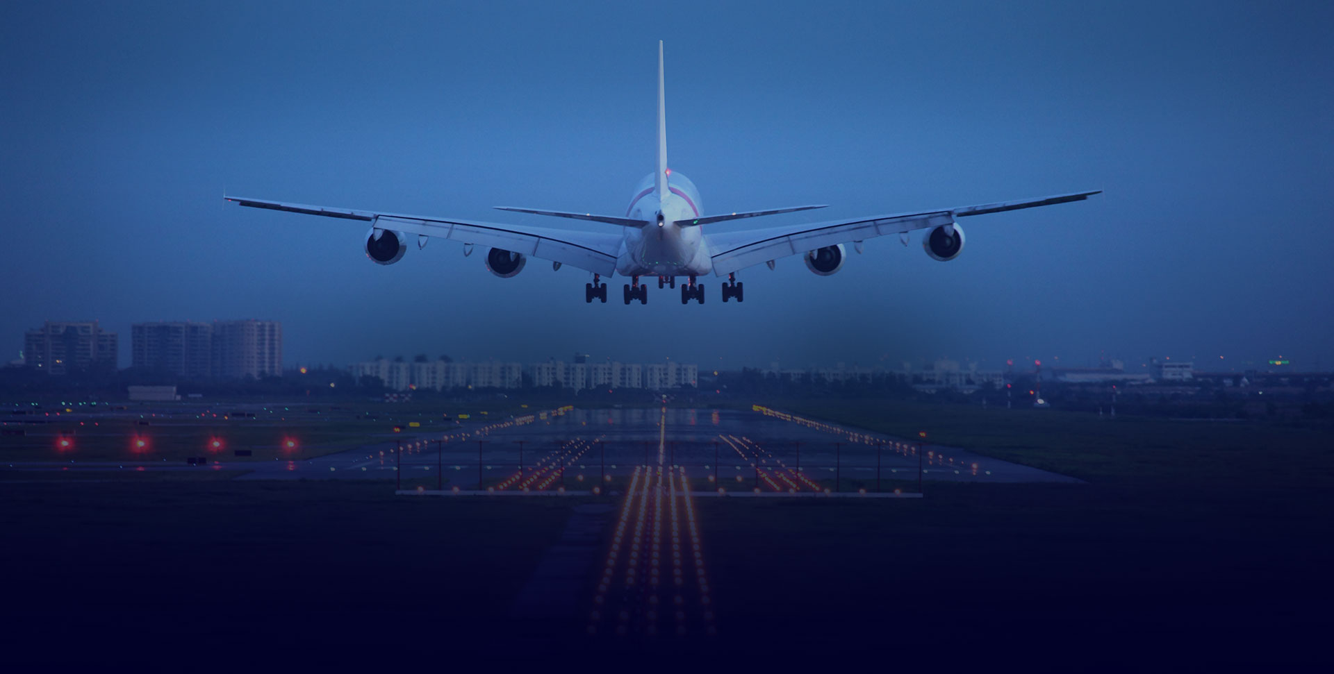 Aircraft approaching a runway at dusk