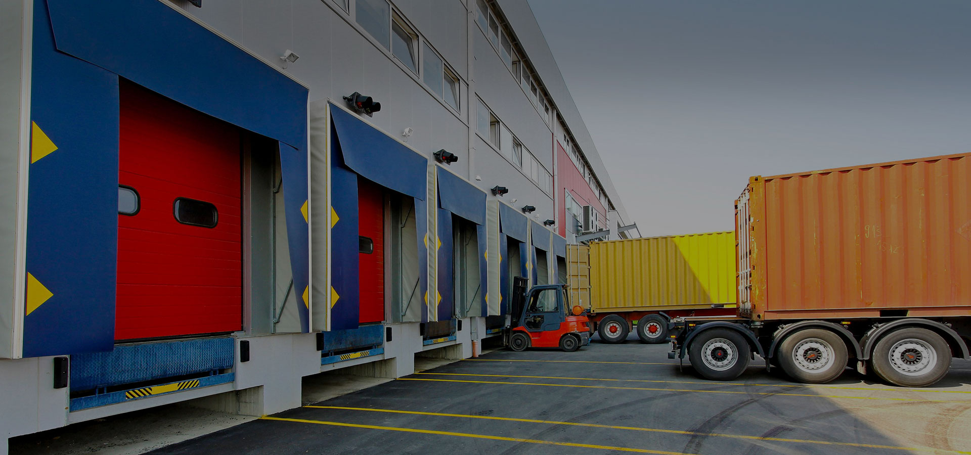Freight containers beside warehouse loading bays